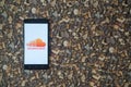 Soundcloud logo on smartphone on background of small stones