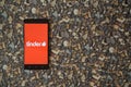 Tinder logo on smartphone on background of small stones