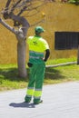 Los Cristianos Teneriffe A local council environmental worker wearing full high visibility protective clothing on a mobile phone