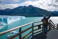 Lonely tourist takes selfie against Perito Moreno glacier and Lago Argentino lake