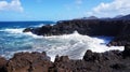 Los Hervideros rocky coast with wavy ocean and volcanos on the background, Lanzarote, Canary Islands, Spain