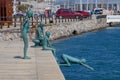 Los Raqueros statue by JosÃÂ© Cobo CalderÃÂ³n in Santander port. Cliff diving sculpture. Boys, children, walk