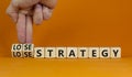 Lose-lose strategy symbol. Businessman turns wooden cubes with words lose lose strategy. Beautiful orange table, orange background Royalty Free Stock Photo