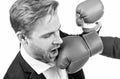 Lose situation. Businessman punched in face. Young man punched with boxing glove. Defeated in fight