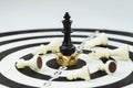 Lose some to win some metaphor in business success strategy or leadership concept, black winner chess king at the center of Royalty Free Stock Photo