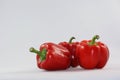 Close up of three red bell peppers on white background Royalty Free Stock Photo