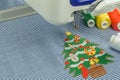 Lose up embroidery machines workspace and Christmas tree Royalty Free Stock Photo