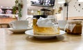 lose-up of piece transparent gelatin cake shortbread dough with meringue cream on table in cafe