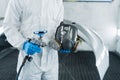 ÃÂ¡lose-up view of car painter with paint gun and protective respirator in hands