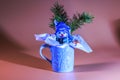 ?lose-up view of Christmas gift chocolate snowman nestled in mug isolated on red background.