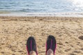 ÃÂ¡lose up view of swimming shoes on  feet of a man against background of white sand beach sea.. Royalty Free Stock Photo