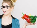 Woman holds shopping basket with vegetables Royalty Free Stock Photo