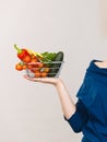 Hand holds shopping cart with vegetables Royalty Free Stock Photo