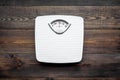 Lose weight concept. Scale on dark wooden background top view Royalty Free Stock Photo