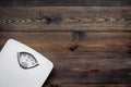 Lose weight concept. Scale on dark wooden background top view copyspace Royalty Free Stock Photo