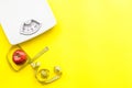 Lose weight concept. Scale and measuring tape on yellow background top view copy space Royalty Free Stock Photo