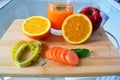 Lose weight, fresh fruits and a glass of orange juice on a wooden board. Royalty Free Stock Photo