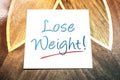 Lose Weight Reminder On Paper Lying On Wooden Table