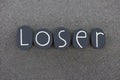 Loser word composed with black painted stone letters over black sand Royalty Free Stock Photo