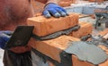 ÃÂ¡loseup of a bricklayer worker installing red bloks and caulking brick masonry joints exterior wall with trowel putty knife Royalty Free Stock Photo