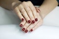 ÃÂ¡loseup of hands of a young woman with long red manicure on nails