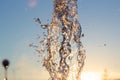 ÃÂ¡loseup jet of water from a fountain hit up against a blue sky, drops of water shimmer in the sun and the rays are reflected. Royalty Free Stock Photo