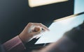 ÃÂ¡loseup of a man pointing to a computer monitor with a blank screen blue against a background of bokeh light in the office Royalty Free Stock Photo