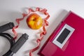 Losing weight concept. Weight scale with a jump rope, red measuring tape and an apple Royalty Free Stock Photo