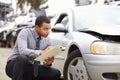 Loss Adjuster Inspecting Car Involved In Accident Royalty Free Stock Photo
