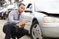 Loss Adjuster Inspecting Car Involved In Accident Royalty Free Stock Photo