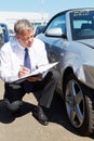 Loss Adjuster Inspecting Car Involved In Accident Royalty Free Stock Photo