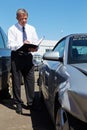 Loss Adjuster Inspecting Car Involved In Accident