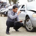 Loss Adjuster Taking Photograph Of Damage To Car Royalty Free Stock Photo