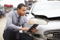 Loss Adjuster Using Digital Tablet In Car Wreck Inspection