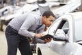 Loss Adjuster Using Digital Tablet In Car Wreck Inspection