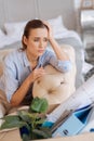 Sad emotional woman leaning her head on the hand while thinking