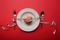 Loss weight and healthy diet concept. Apple, measure tape, spoon and fork on red background. Royalty Free Stock Photo