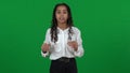 Lost African American teenage girl shouting holding hands at mouth on green screen. Portrait of disorientated teenager