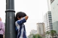 Lost Asian Child Seems Crying Lean Back His Body to a City Lamp Pole Royalty Free Stock Photo