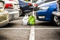 Lost bagages in the parking through the cars. Forgoten bags on the city parking Royalty Free Stock Photo