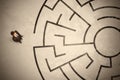 Lost business man looking for a way in circular labyrinth Royalty Free Stock Photo