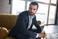 Lost in business thoughts...Thoughtful handsome young businessman is thinking about business while sitting on the sofa Royalty Free Stock Photo