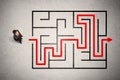 Lost businessman found the way in maze with red arrow Royalty Free Stock Photo