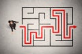 Lost businessman found the way in maze with red arrow Royalty Free Stock Photo