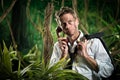 Lost businessman having a phone call in the jungle. Royalty Free Stock Photo