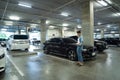 Lost car concept : Stressed woman holding car keys in her hands where her car was stolen leaving only empty space