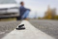 Lost car keys lying on the roadway, on a blurred background with bokeh effect Royalty Free Stock Photo