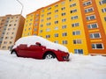 Lost car under huge snow and yellow orange resident house Royalty Free Stock Photo