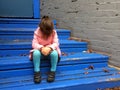 Lost child cries on steps Royalty Free Stock Photo