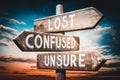 Lost, confused, unsure - wooden signpost, roadsign with three arrows Royalty Free Stock Photo